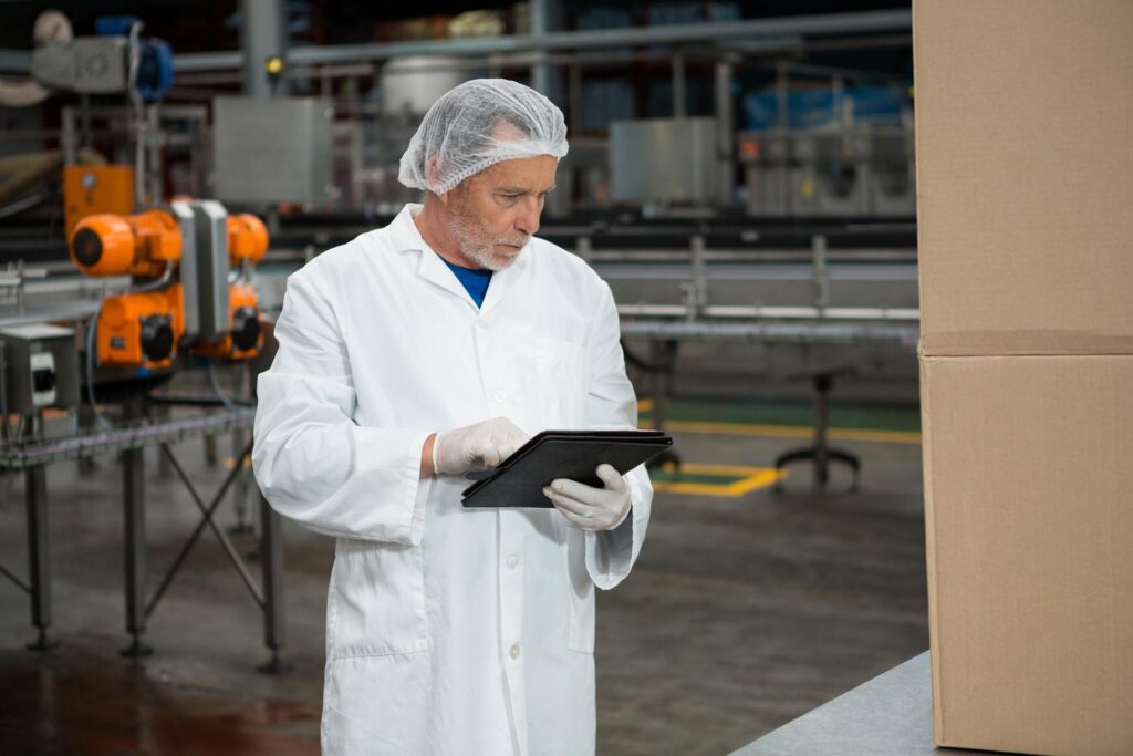 male-worker-using-digital-tablet-cold-drink-factory